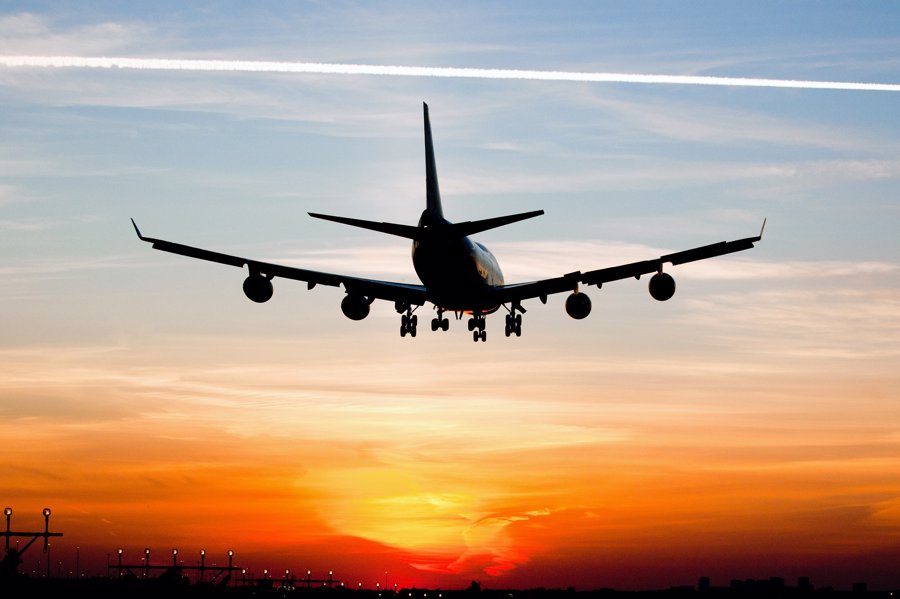 Plane landing by sunrise